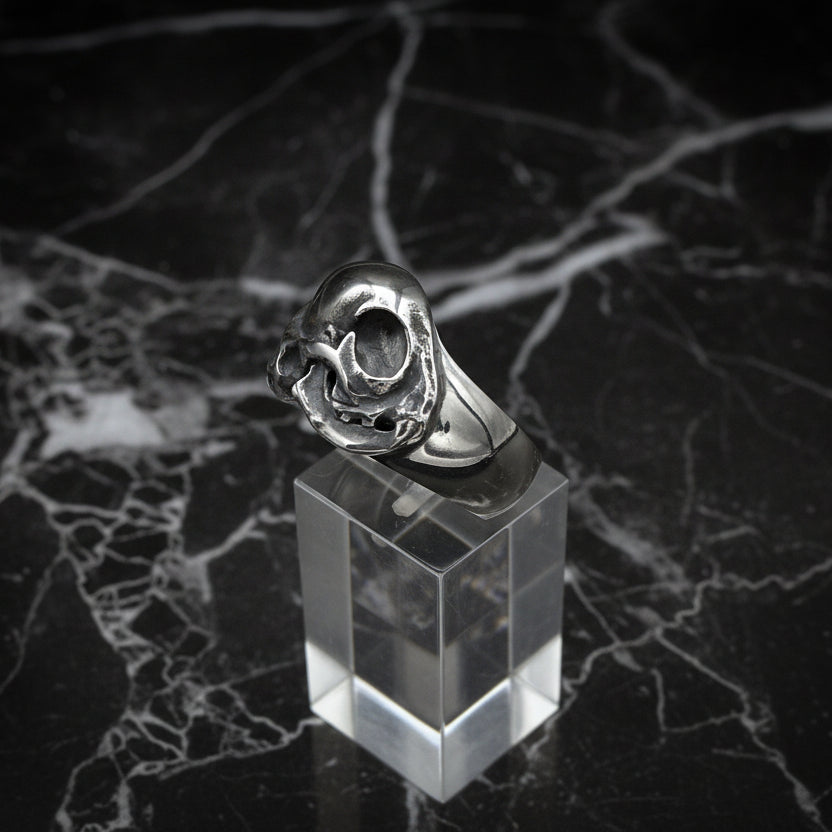 Silver cat skull ring on a black background