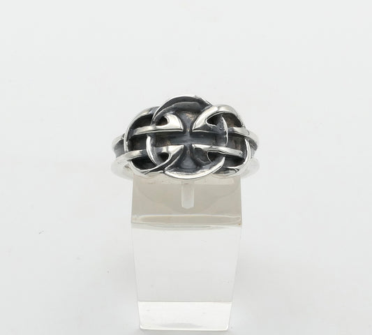 Silver Celtic ring with a unique design on a clear stand against a white background