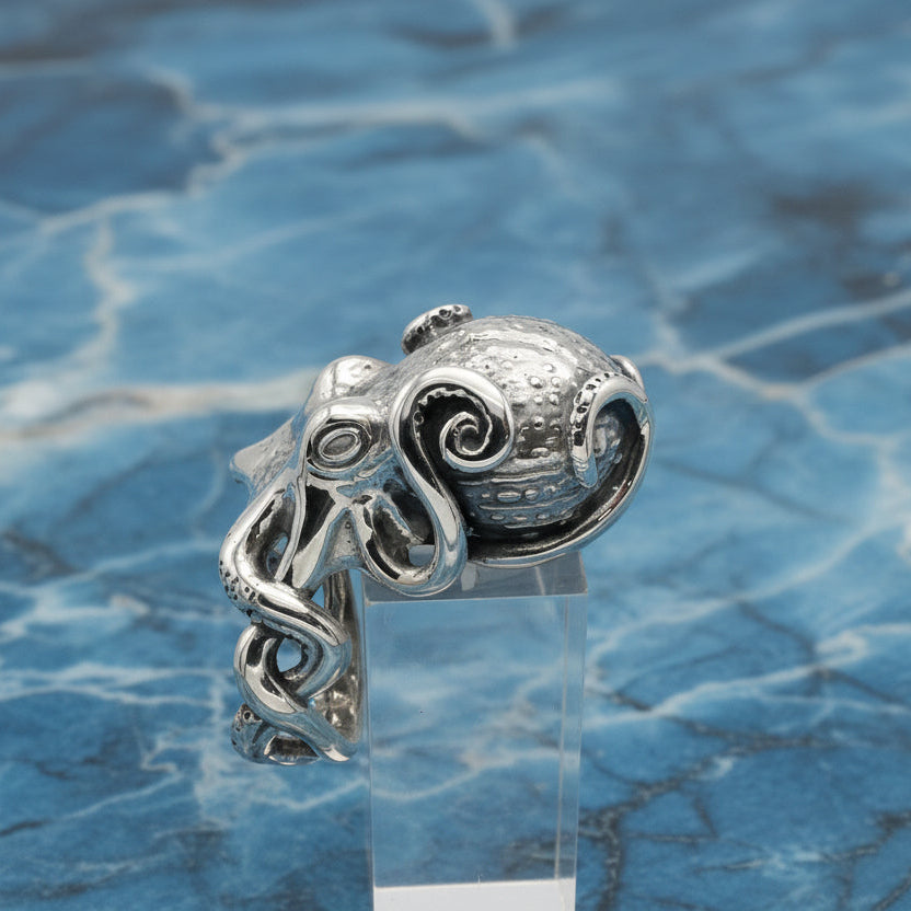 Silver octopus ring on a blue marble background