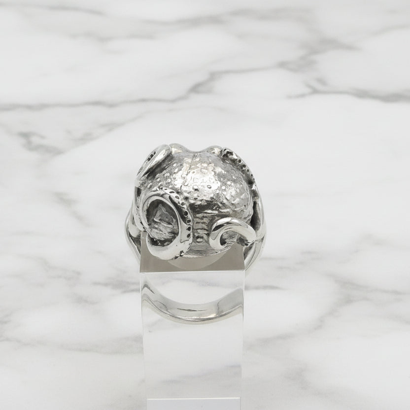 Silver octopus ring with textured design on a white background