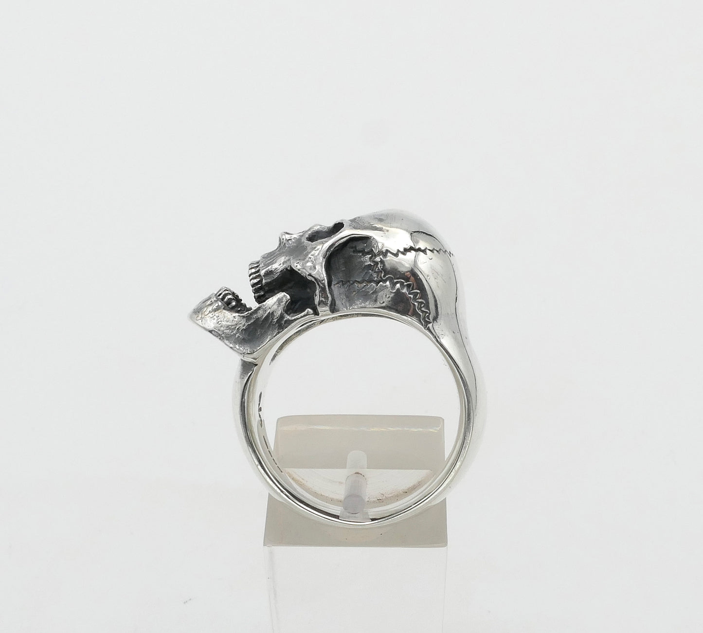 Silver skull ring with a unique design on a white background