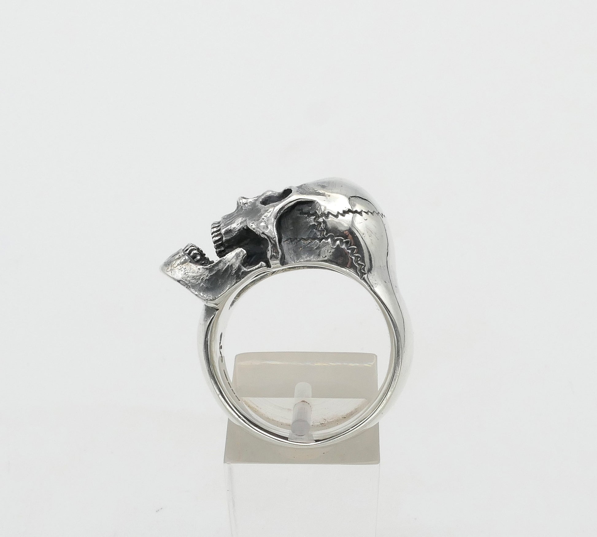 Silver skull ring with a unique design on a white background