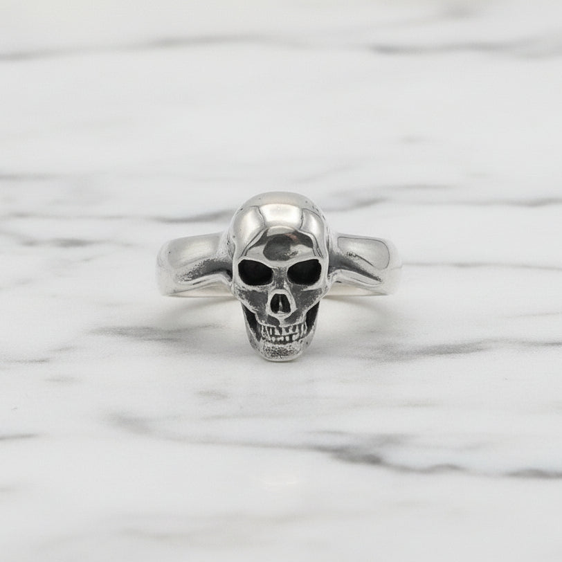 Silver skull ring on a white background