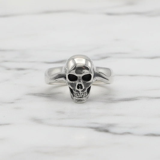 Silver skull ring on a white background