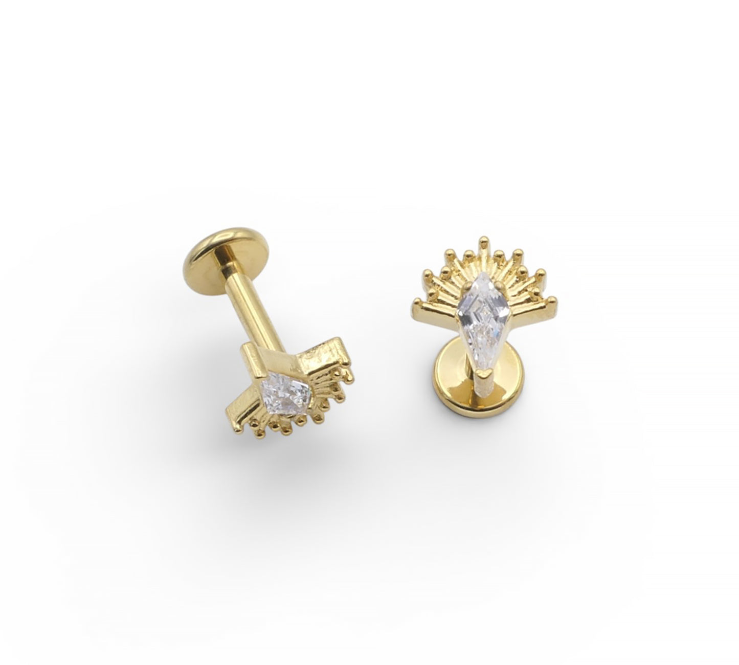 Gold earrings with clear gemstones on a white background