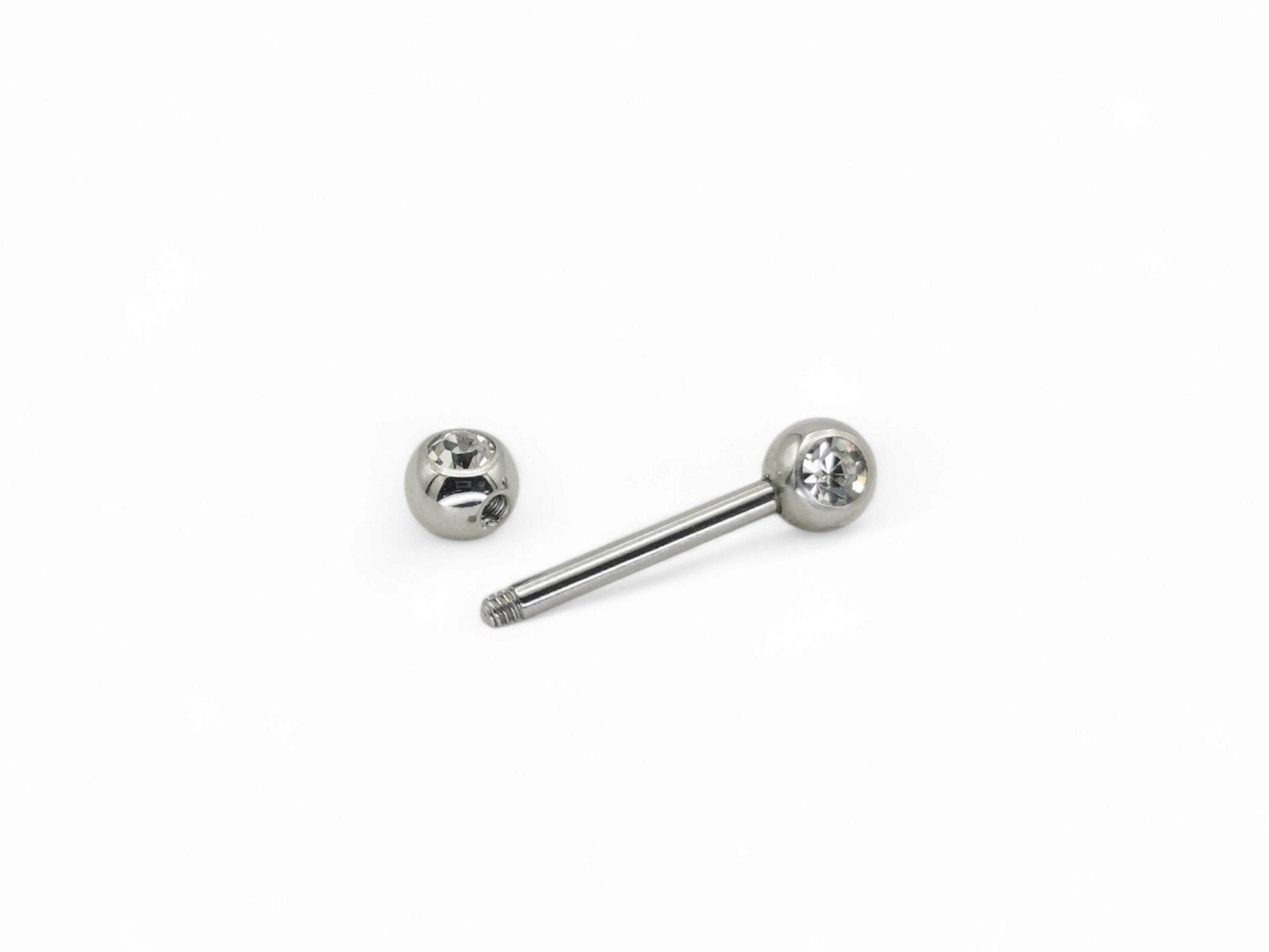 A set of three surgical steel barbells with jewelled ends, varying in length, on a white background.