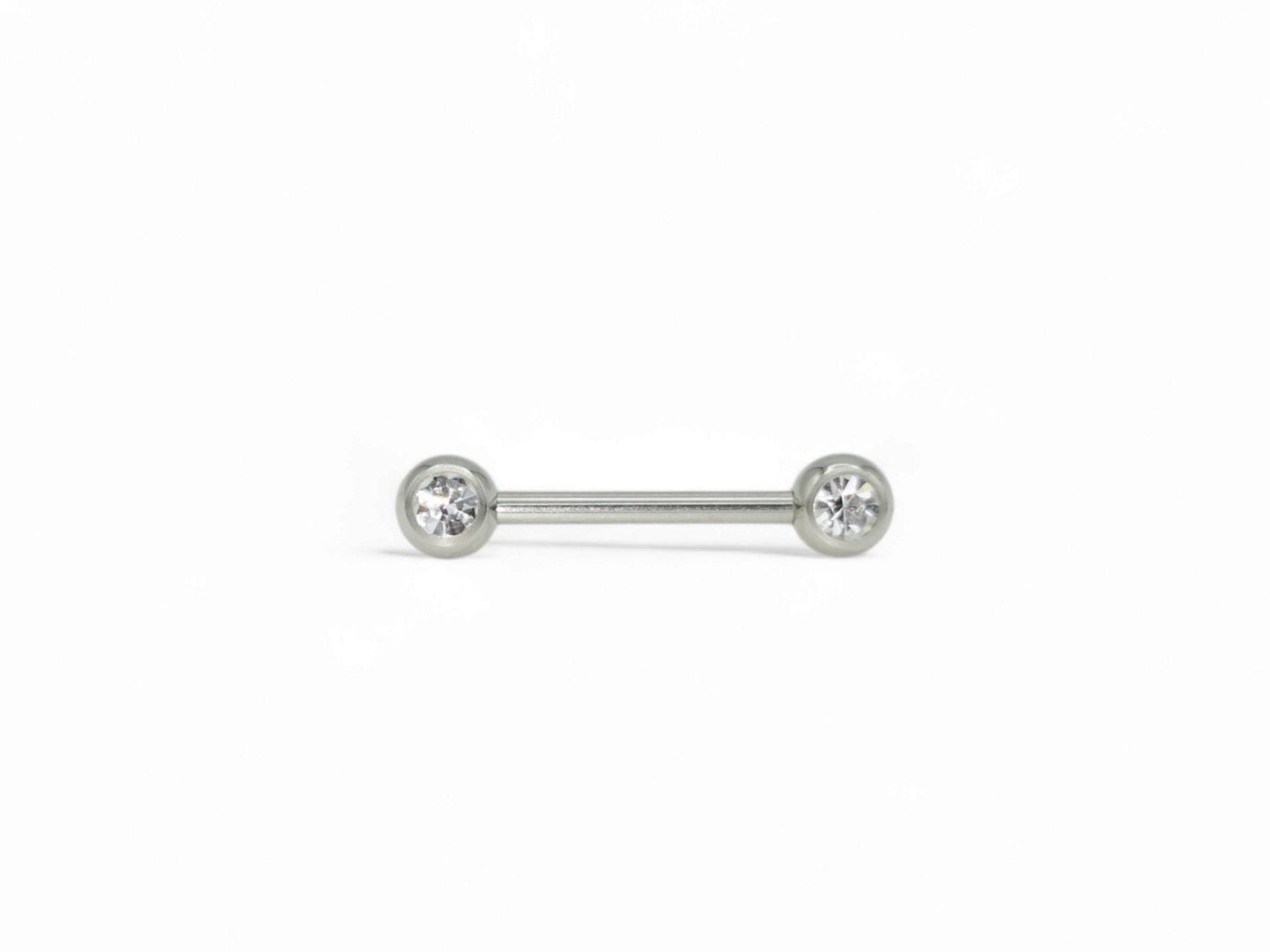 A set of three surgical steel barbells with jewelled ends, varying in length, on a white background.
