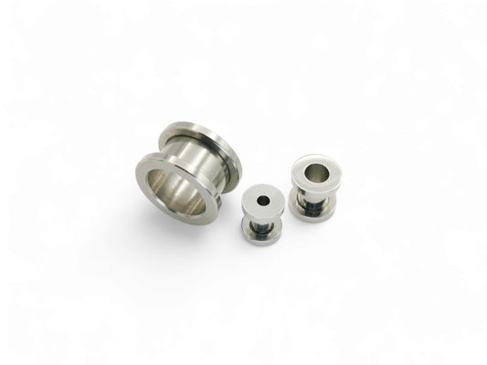Surgical steel screw fit ear gauges on a white background
