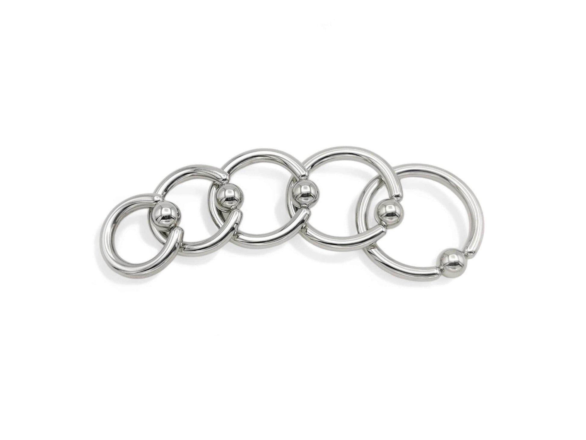A set of five surgical steel BCRs with a ball closure design on a white background