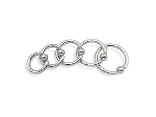 A set of five surgical steel BCRs with a ball closure design on a white background