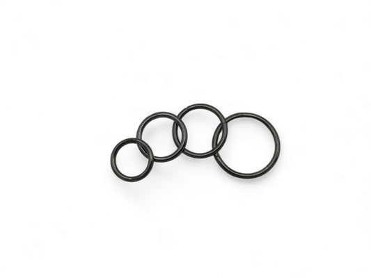 Three black surgical steel clicker rings for ear and nose piercings, presented on a white background.