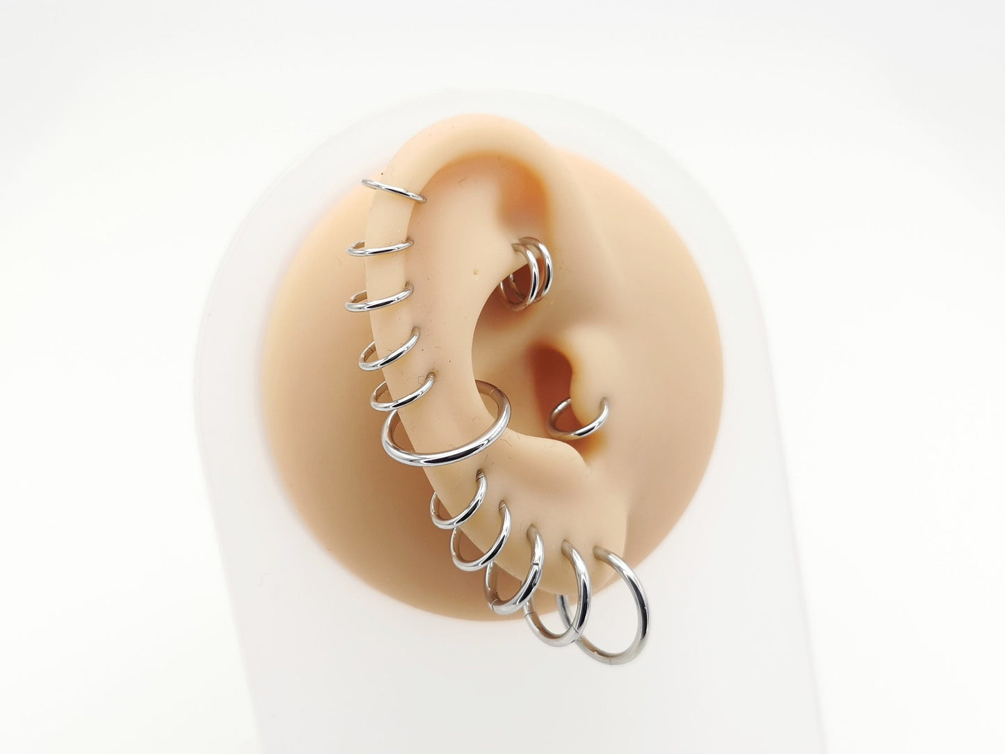 A selection of silver surgical steel clicker rings, with varying internal diameters for ear and nose piercings.