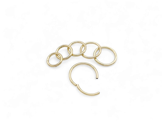 Gold PVD surgical steel clicker rings on a white background