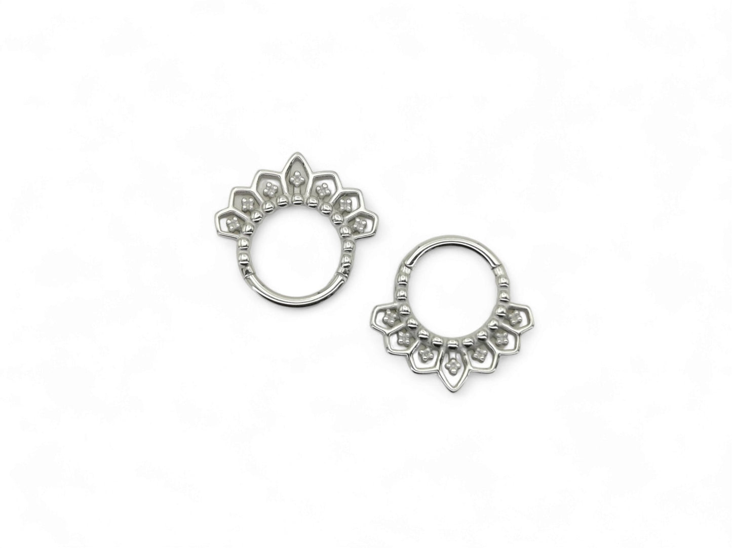 Surgical steel mandala clicker rings, for septum or a daith piercing, with intricate filigree patterns on a white background