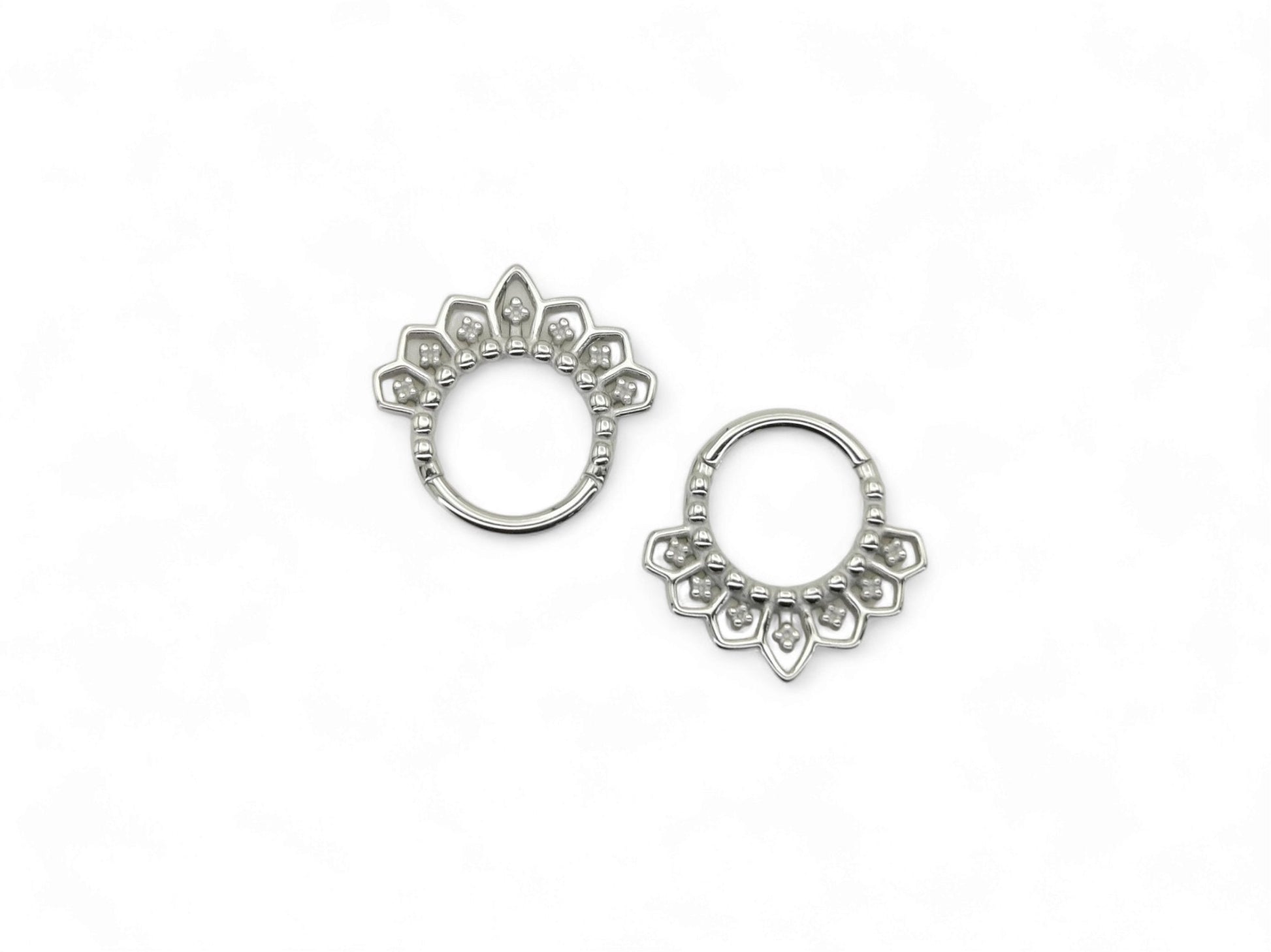 Surgical steel mandala clicker rings, for septum or a daith piercing, with intricate filigree patterns on a white background