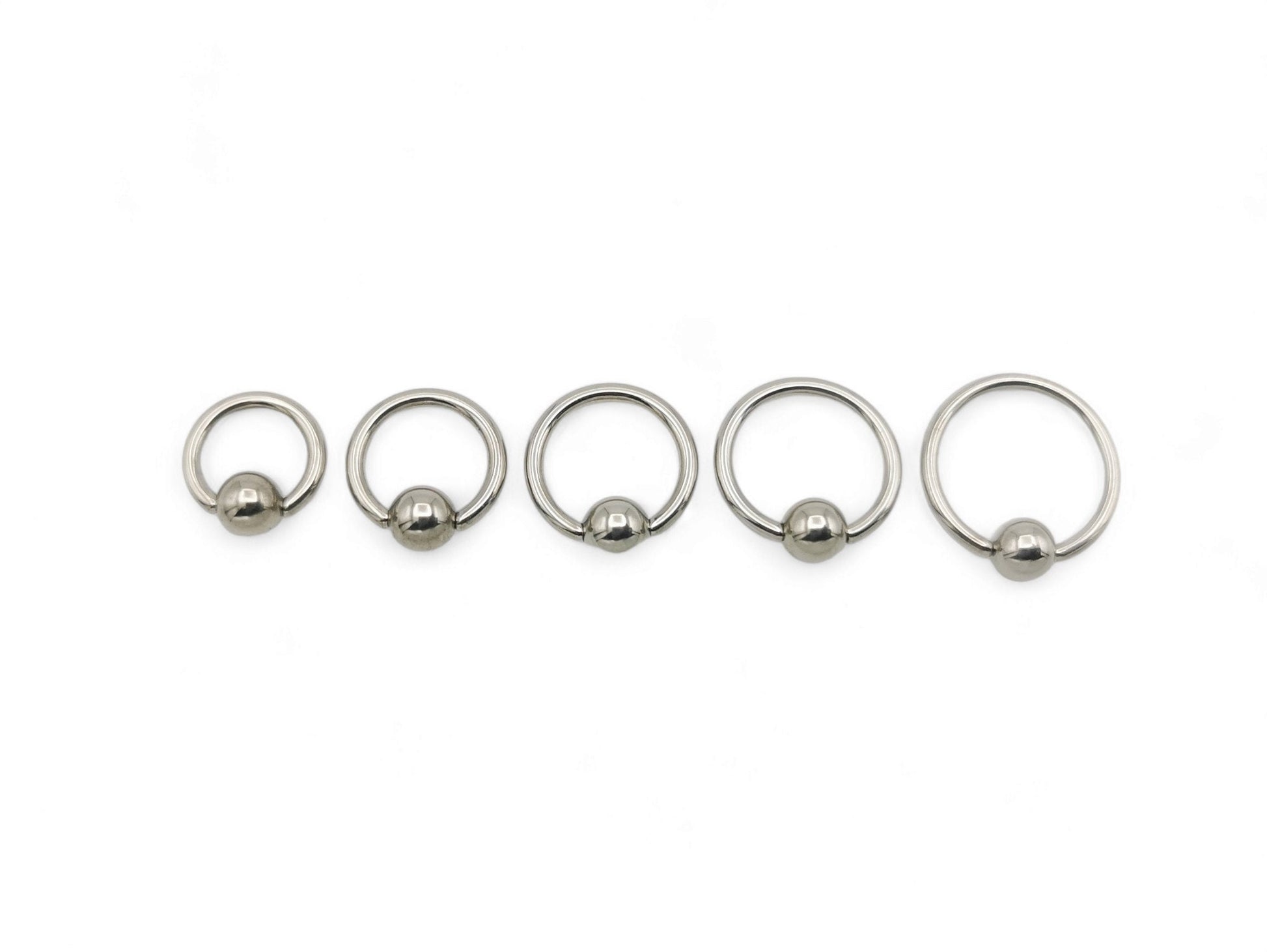 A polished titanium BCR with a high polished finish, designed for 1.2mm/16g piercings, featuring a ball closure mechanism.