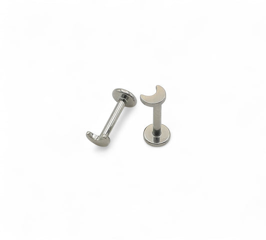 Titanium crescent moon push fit studs on a white background