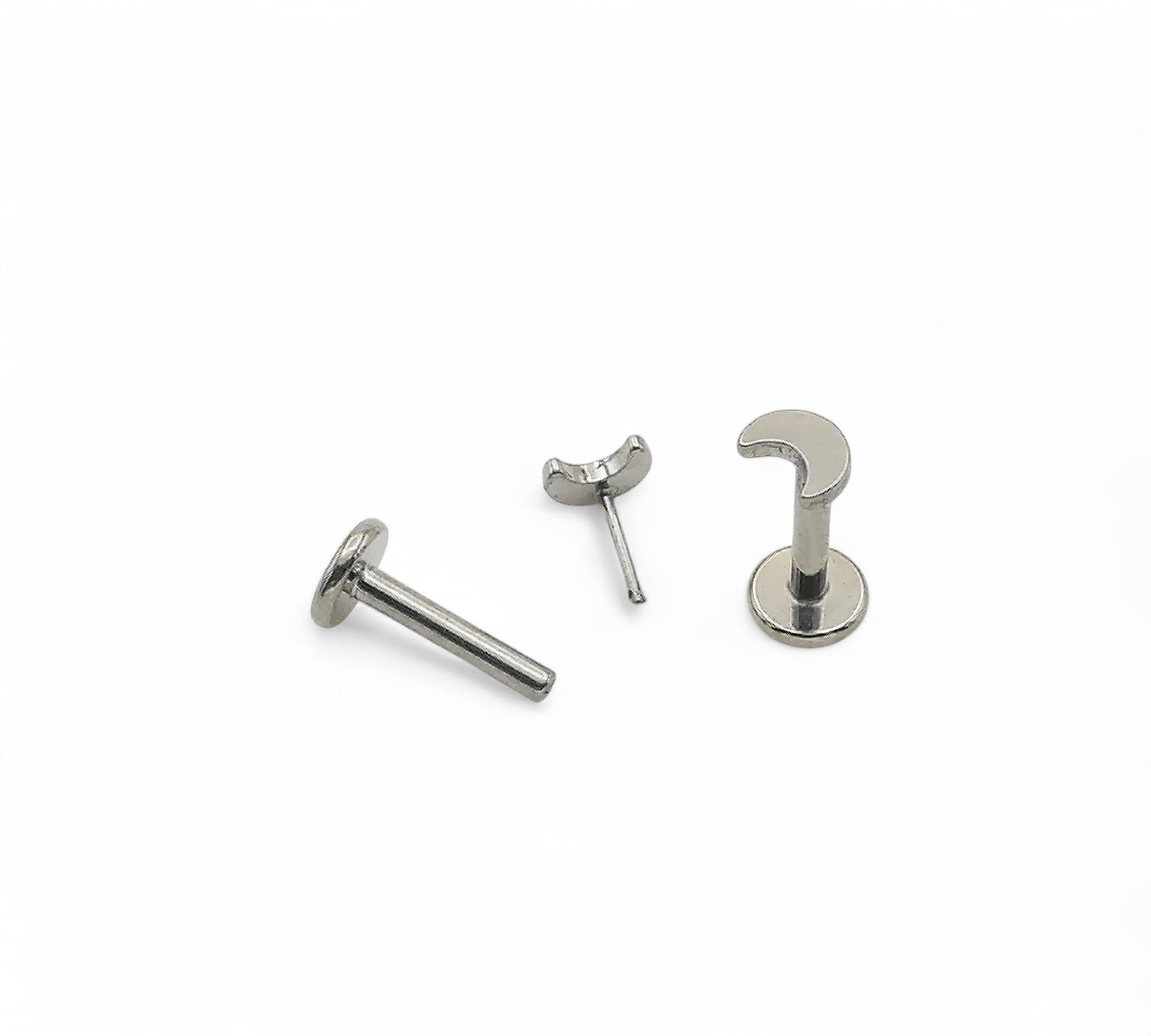 Three titanium crescent moon push-fit Studs on a white background