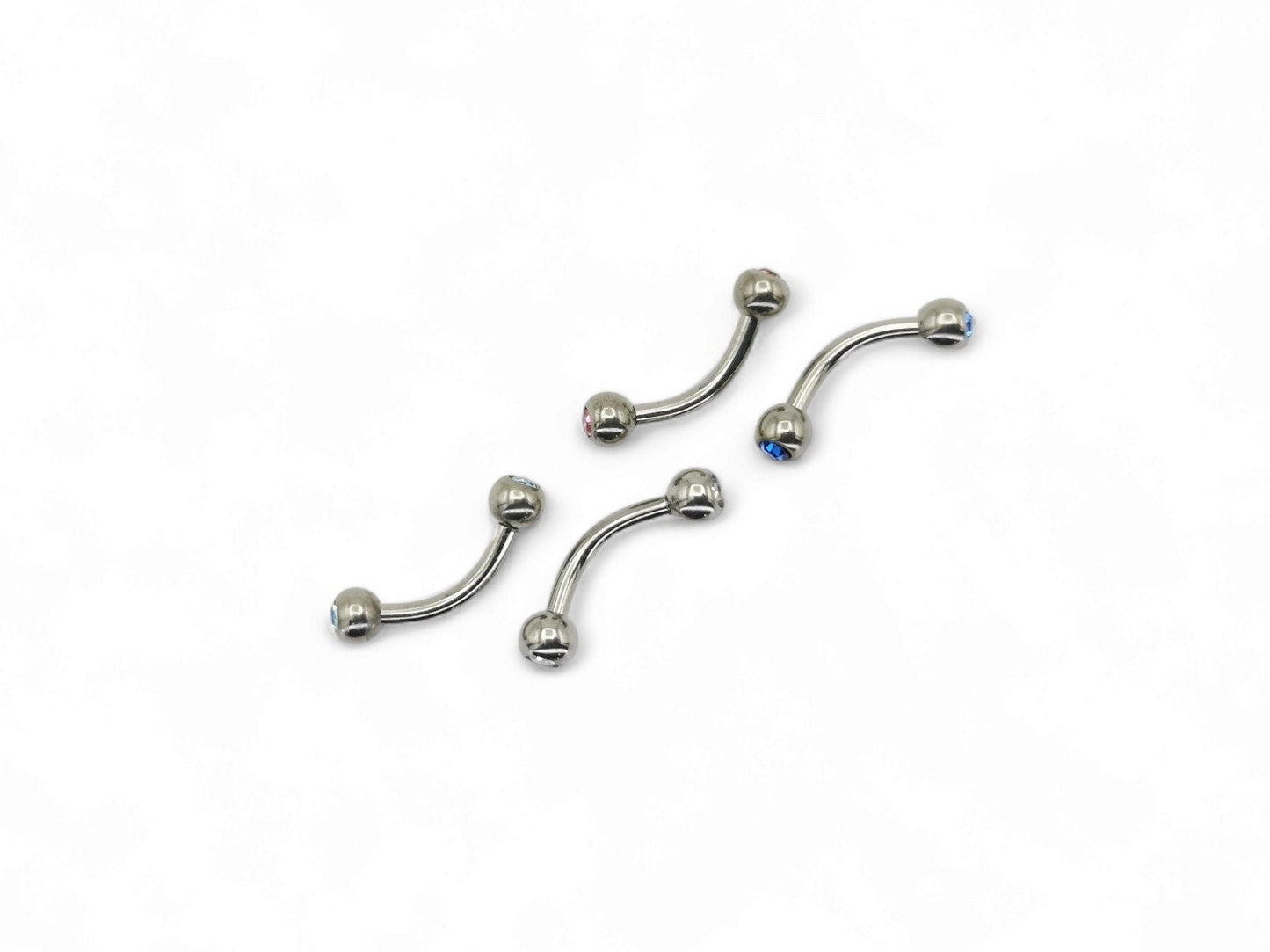 Titanium barbells with gemset crystals on both ends, available in multiple colors.