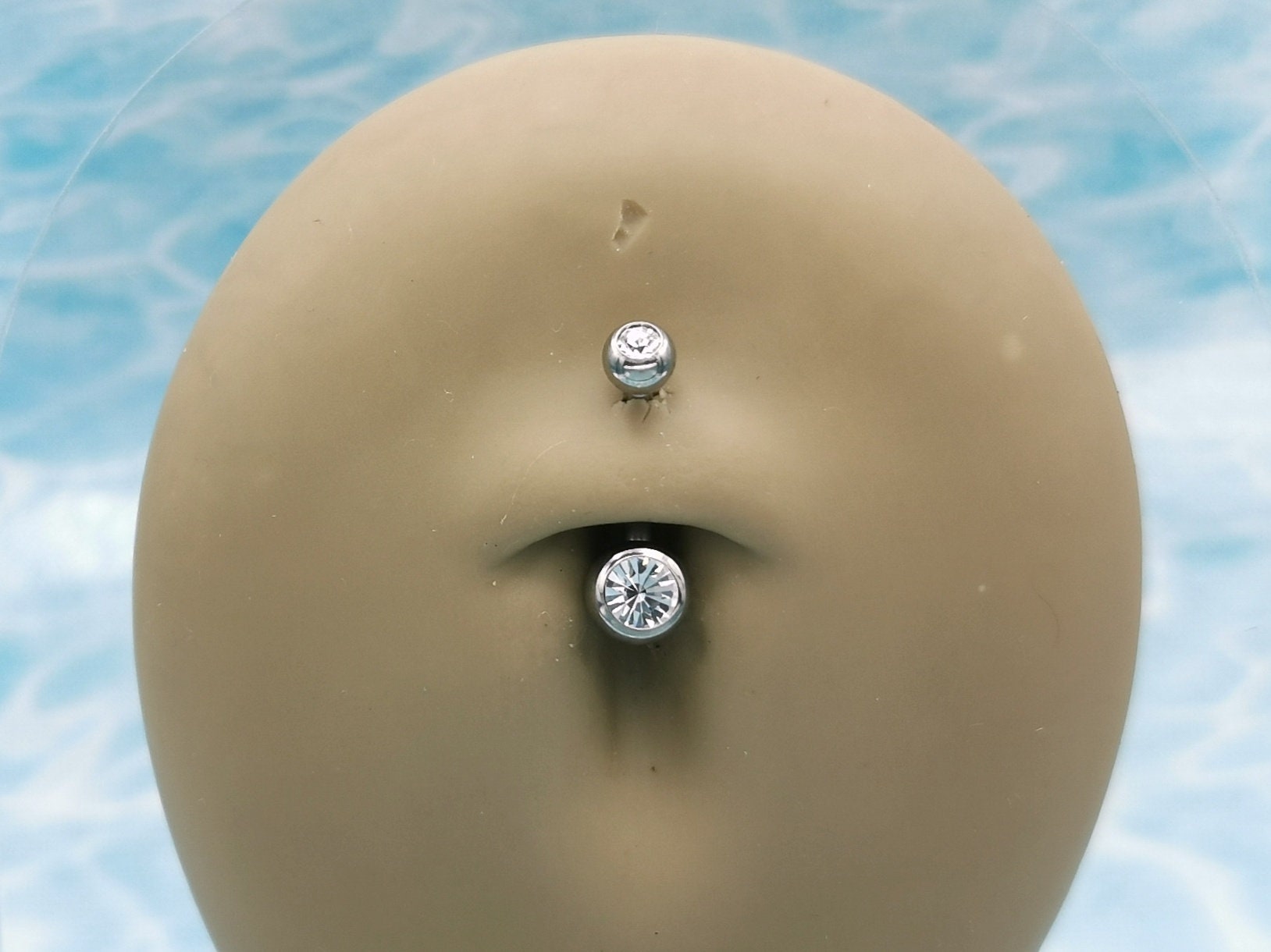 Titanium Double Jewelled Belly Bar on a stand