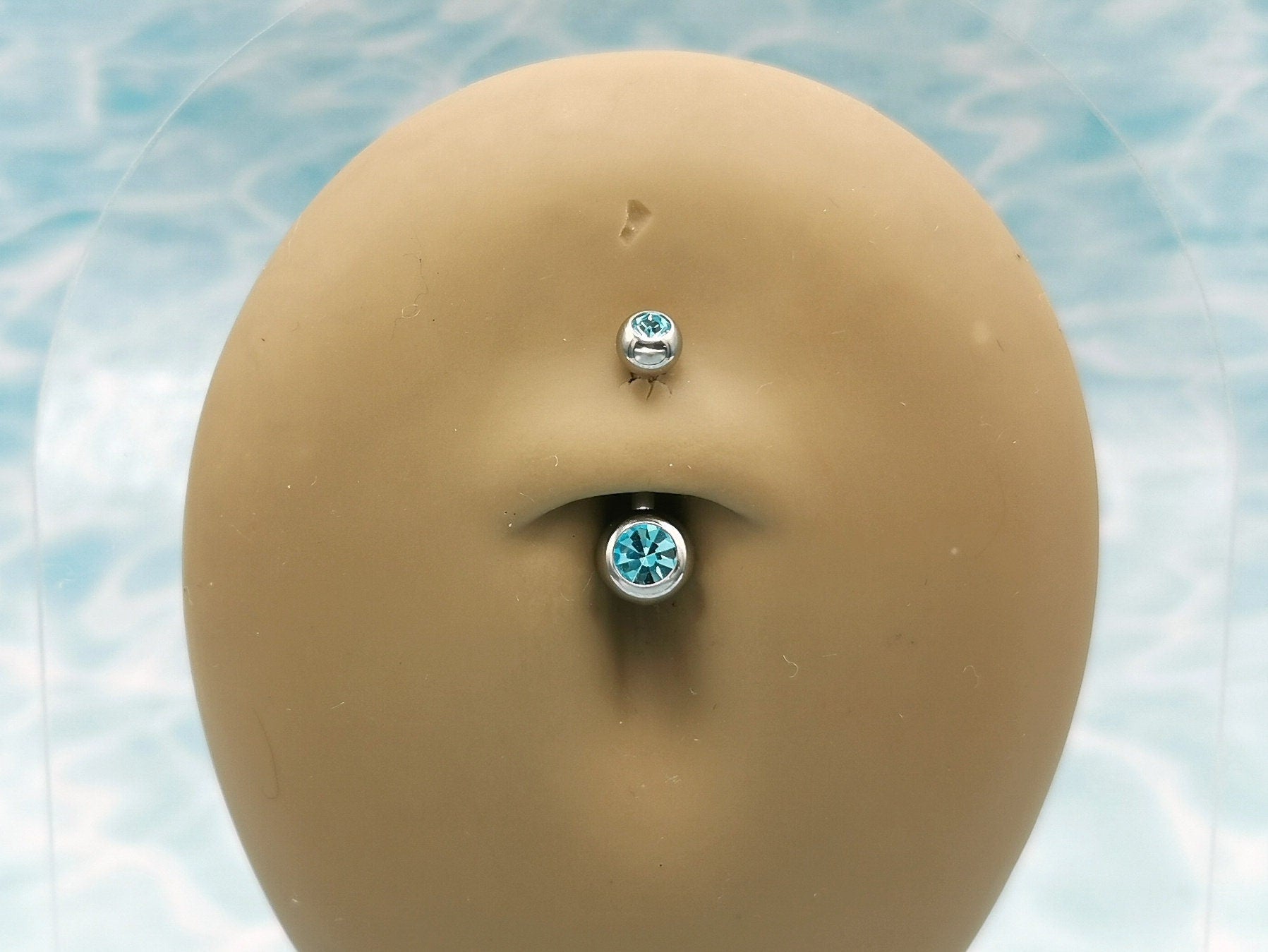 Titanium Double Jewelled Belly Bar on a stand