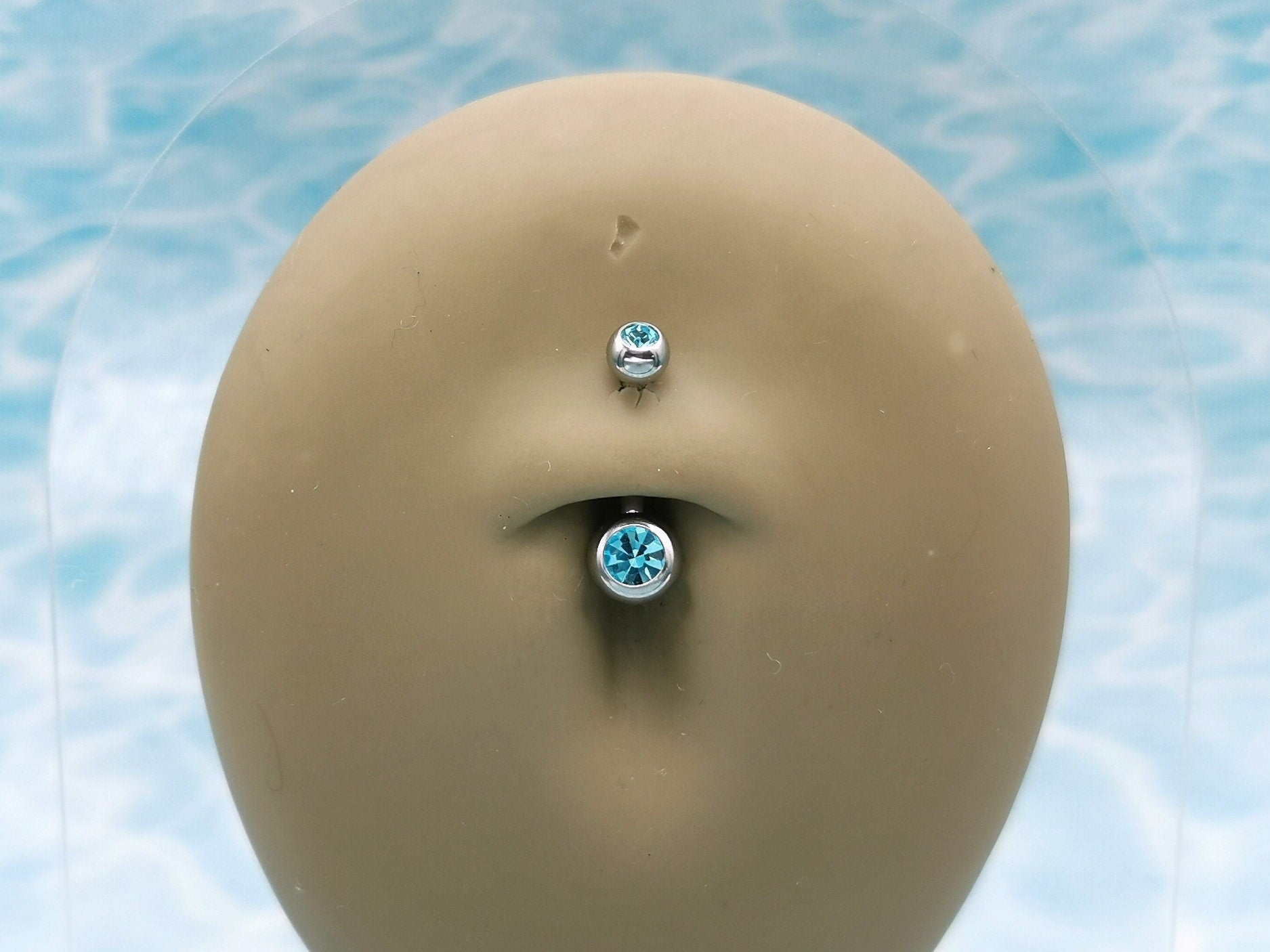 Titanium Double Jewelled Belly Bar on a stand