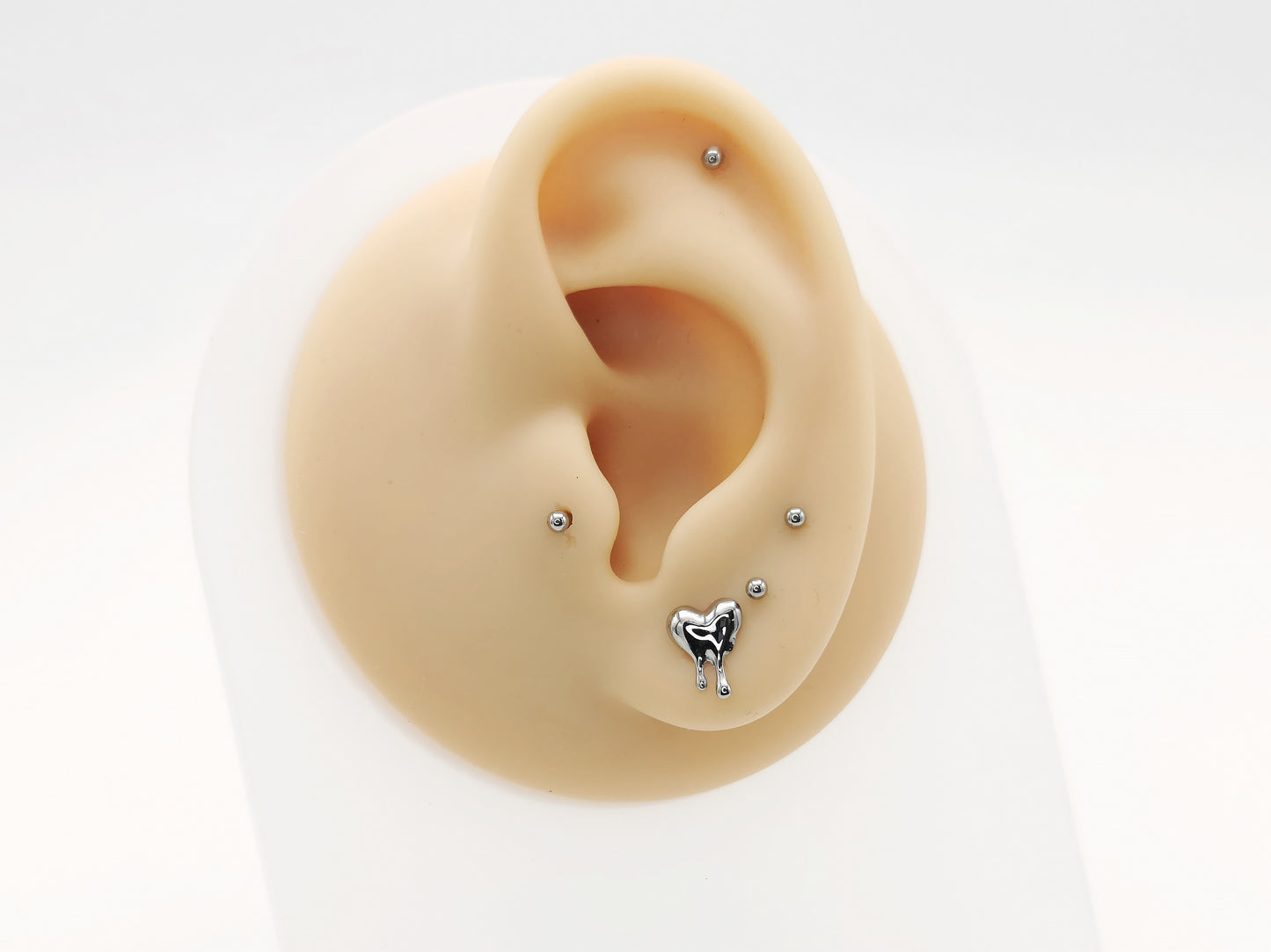 Titanium Melting Heart Stud on a mannequin ear