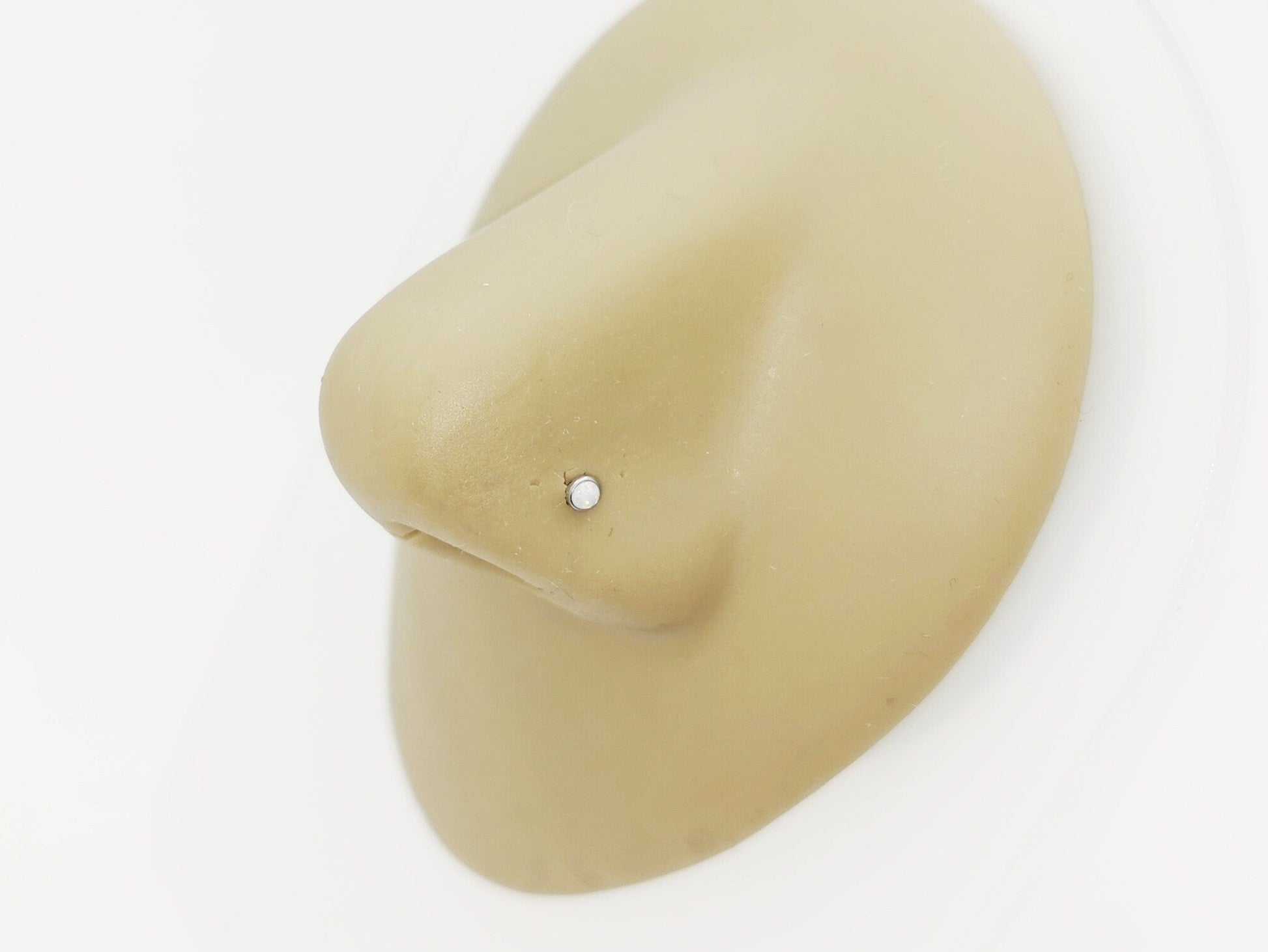 Titanium Opal Nose Stud on a nose