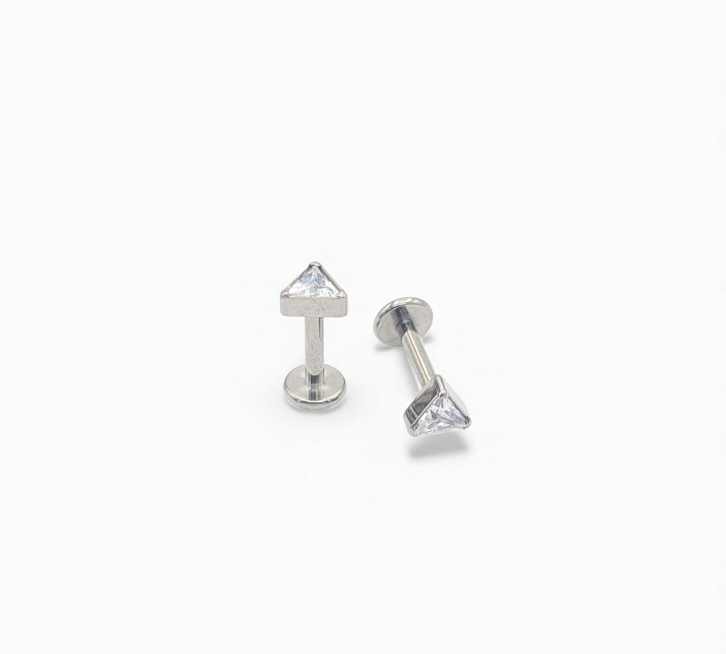 Two silver stud earrings with clear gemstones on a white background