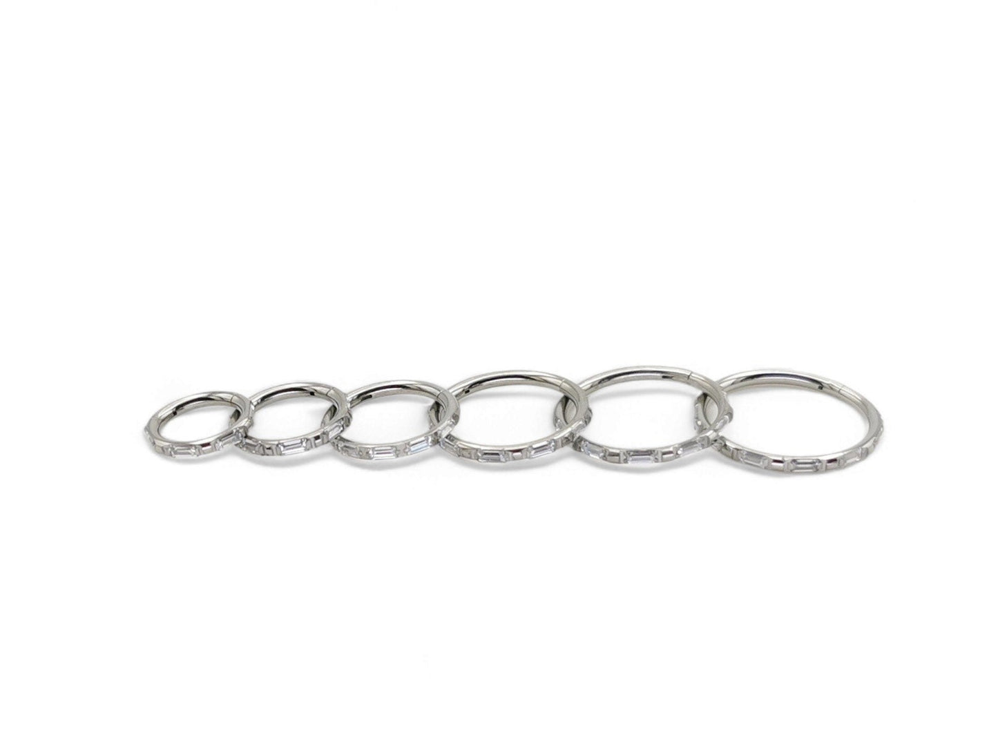 A single titanium baguette jewelled clicker with a hinged section, intended for use with 1.2mm/16g piercings.
