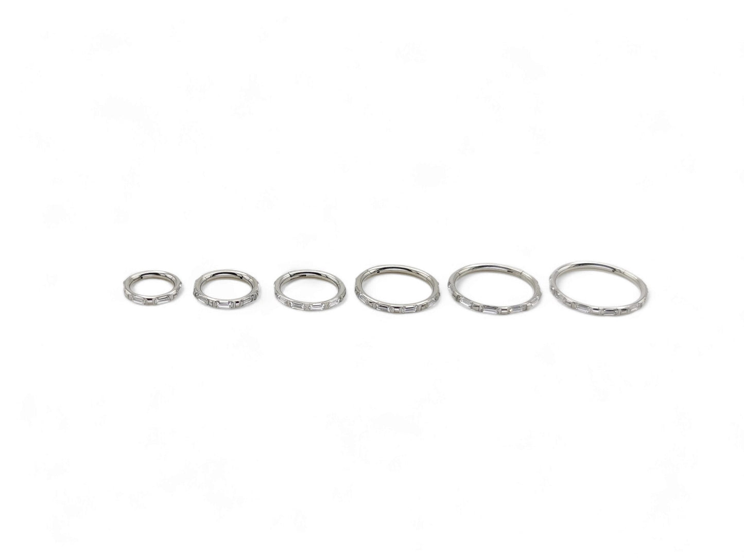 A single titanium baguette jewelled clicker with a hinged section, intended for use with 1.2mm/16g piercings.