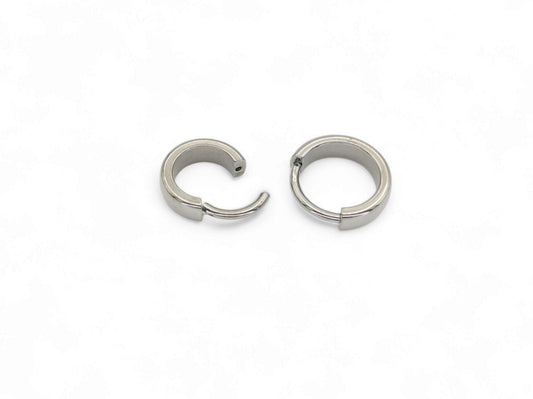 Two titanium band clicker rings for ear and septum piercings, with a 1.2mm width, displayed on a white background.
