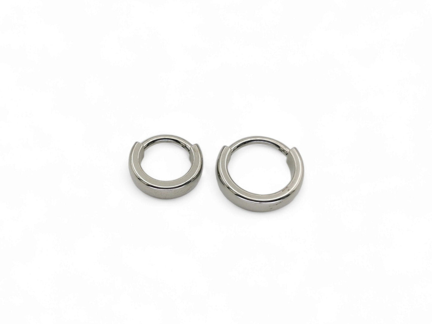 Two titanium band clicker rings for ear and septum piercings, with a 1.2mm width, displayed on a white background.