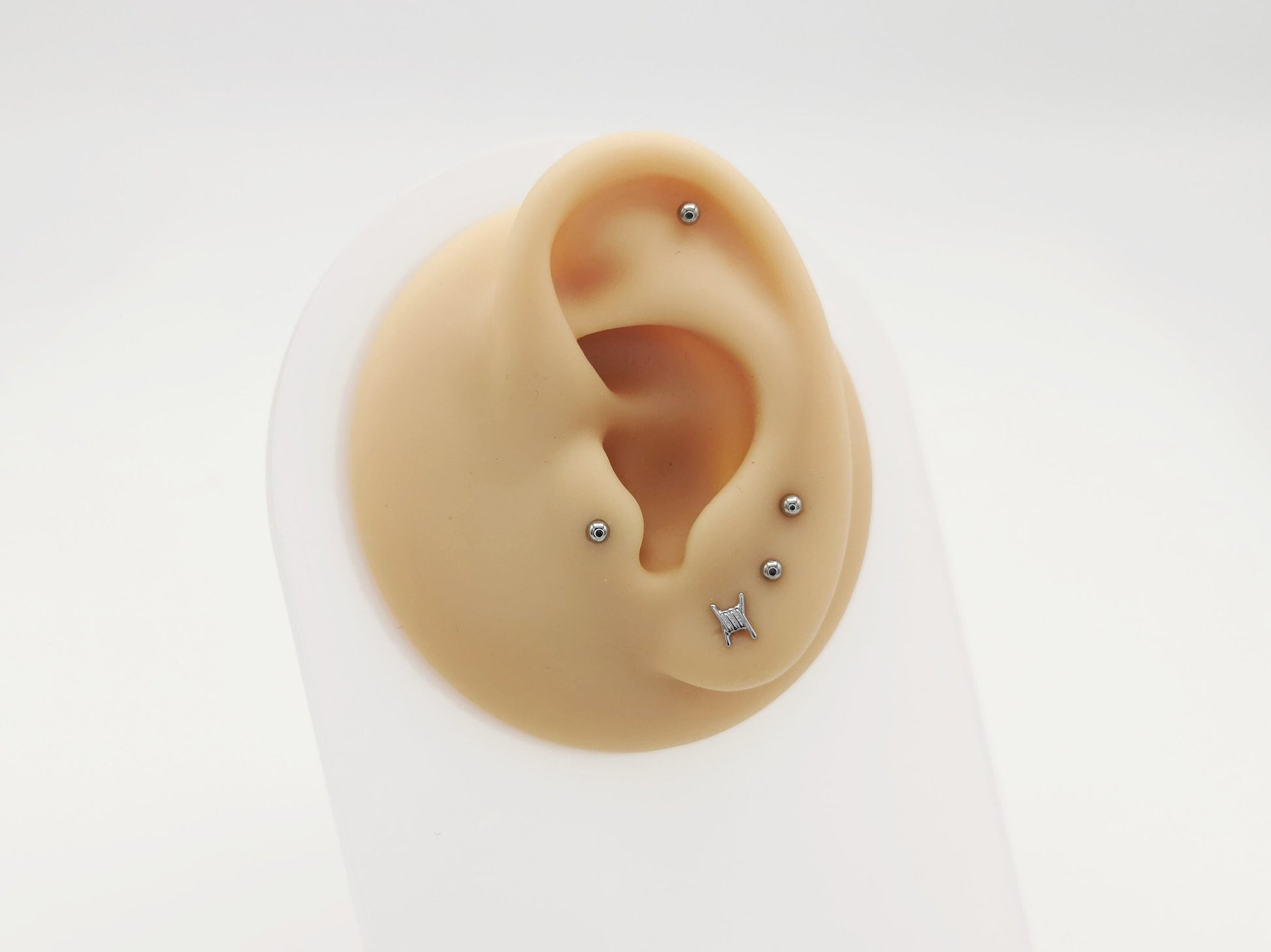 Two titanium barb wire threadless studs with a push-fit design