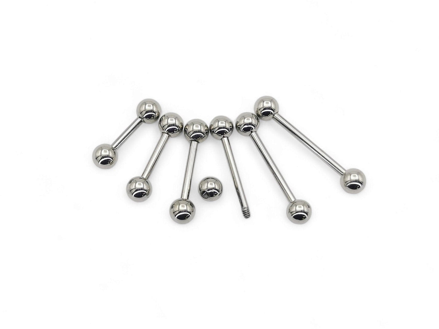 A set of polished titanium barbells with varying lengths, designed for piercings, presenting a metallic sheen.