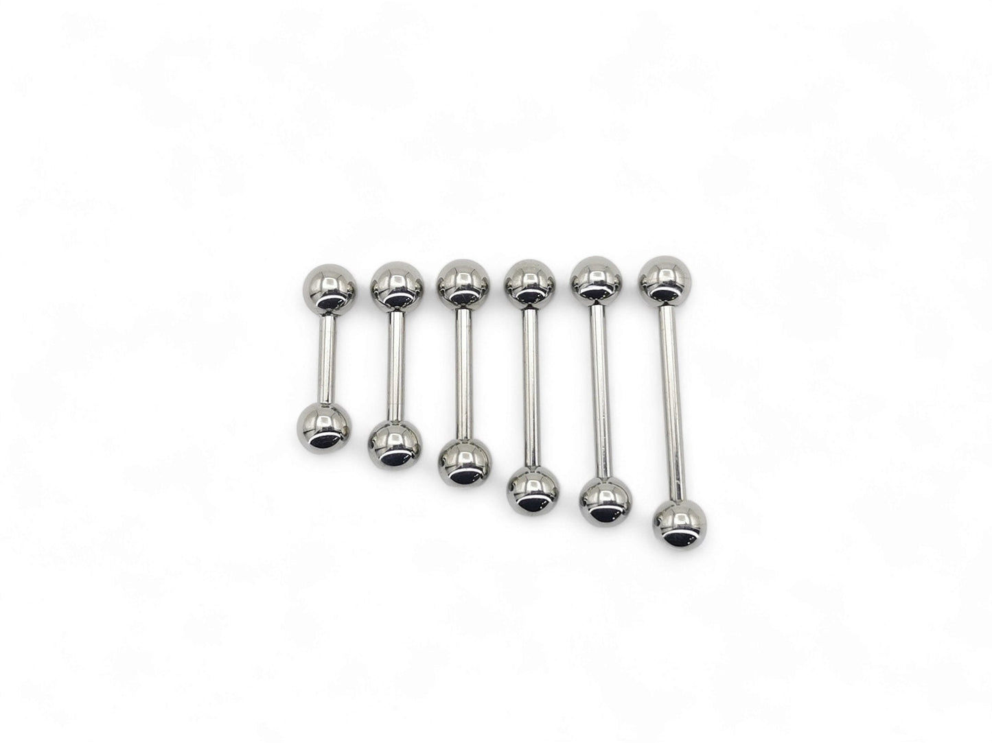 A set of polished titanium barbells with varying lengths, designed for piercings, presenting a metallic sheen.