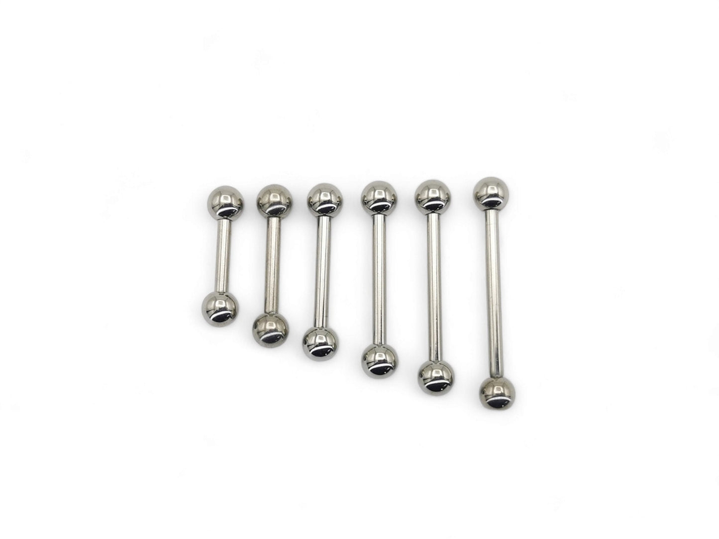 A set of polished titanium barbells with varying lengths, designed for piercings, presenting a metallic sheen.