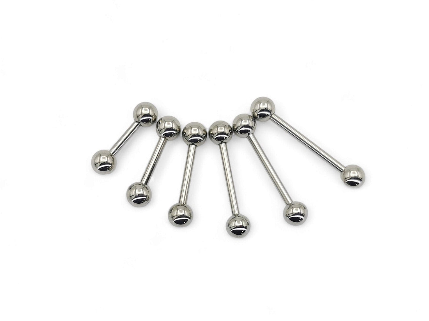 A set of polished titanium barbells with varying lengths, designed for piercings, presenting a metallic sheen.