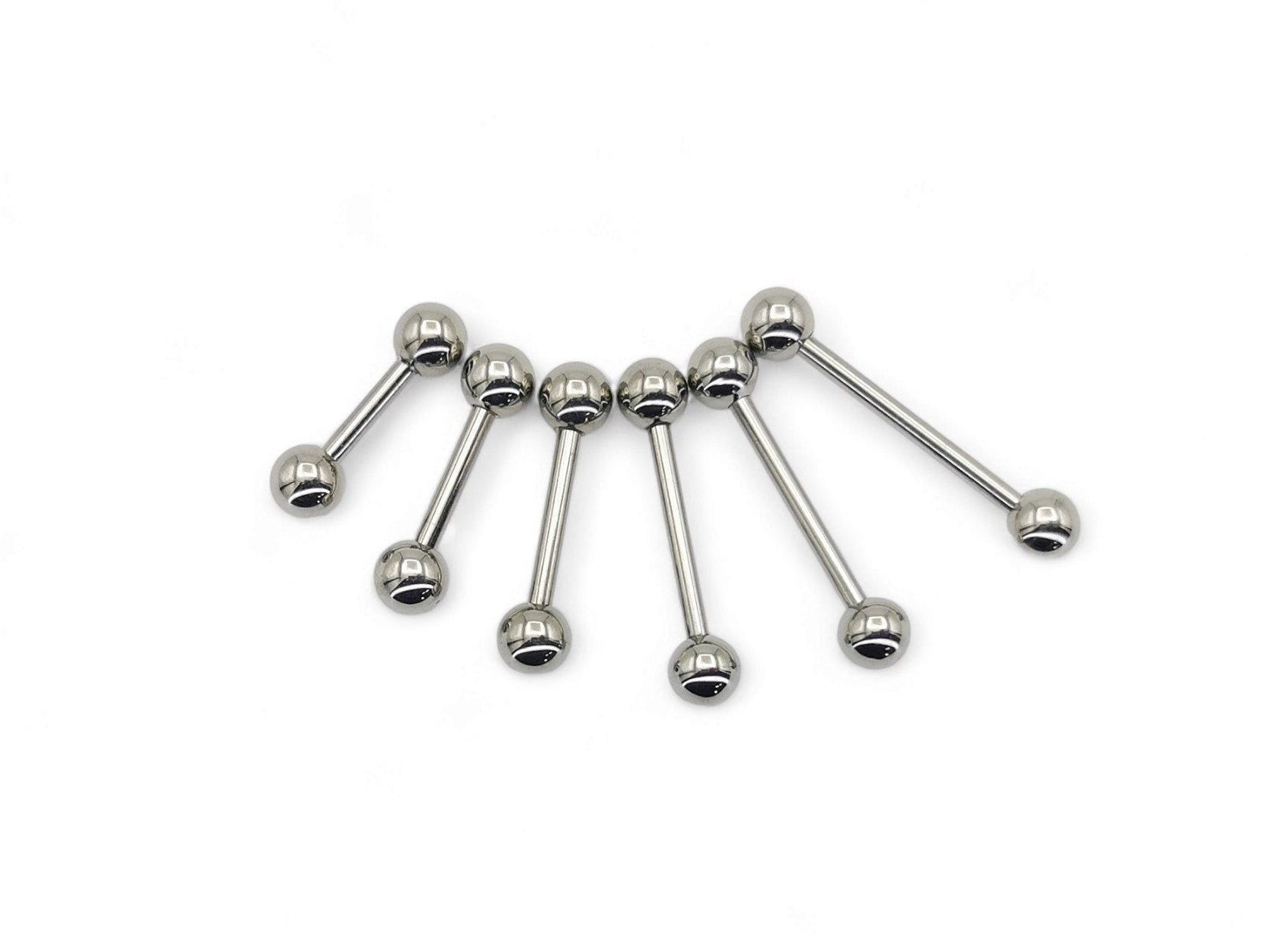 A set of polished titanium barbells with varying lengths, designed for piercings, presenting a metallic sheen.
