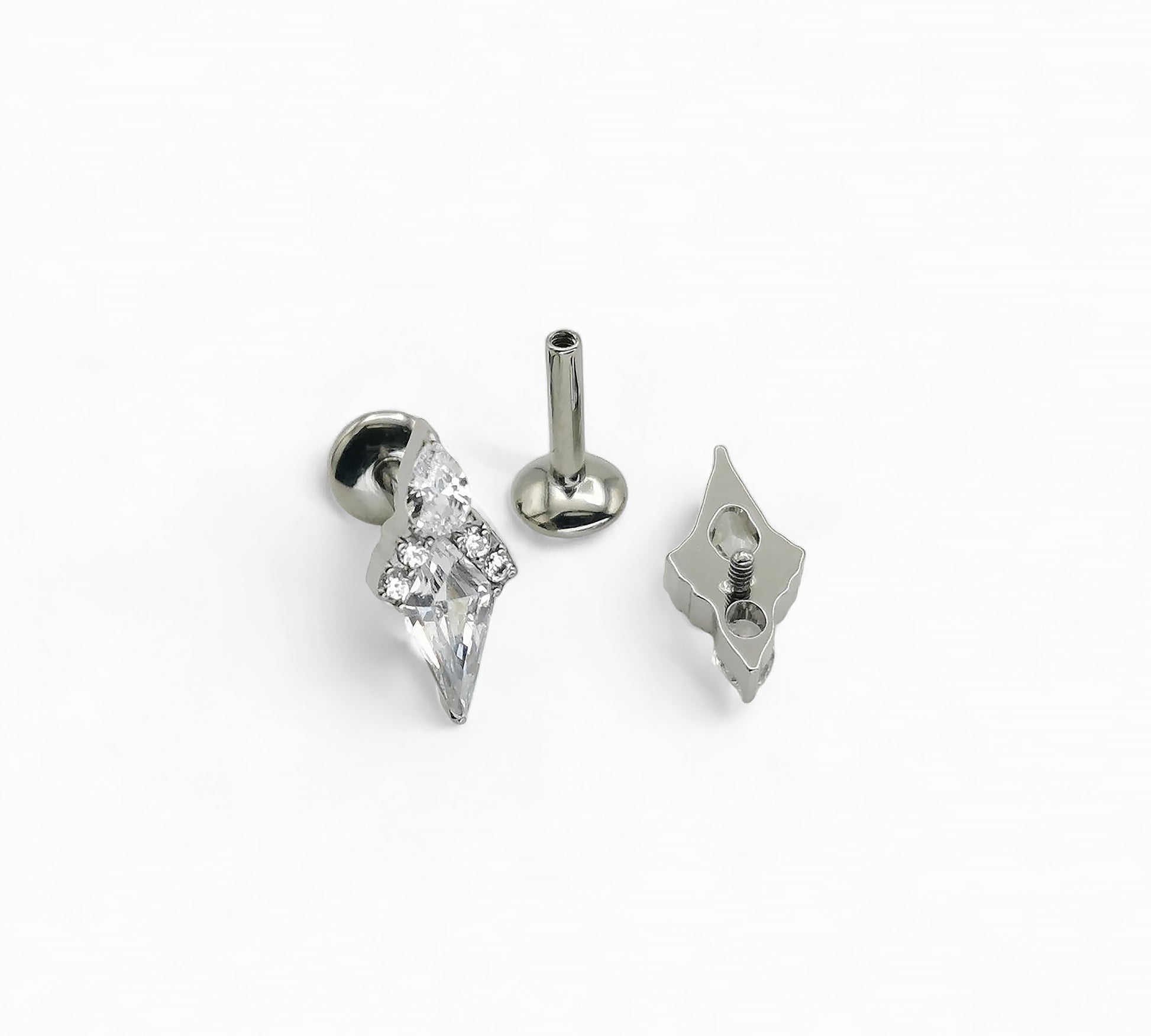 Silver earring with clear gemstone on a white background