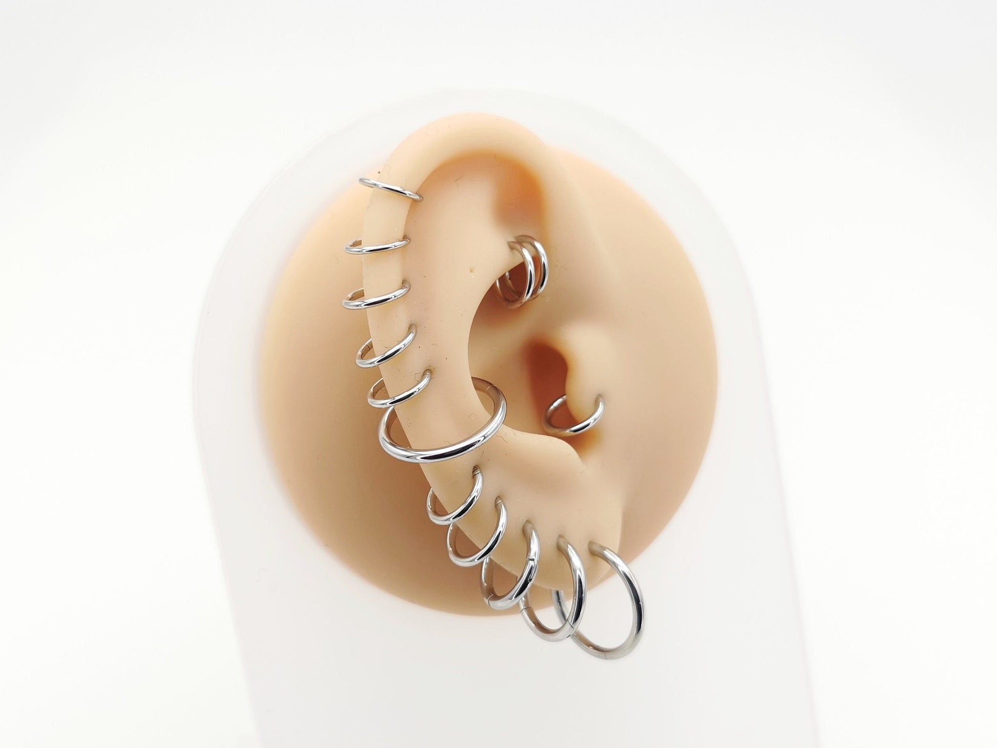 Titanium clicker rings on a mannequin ear