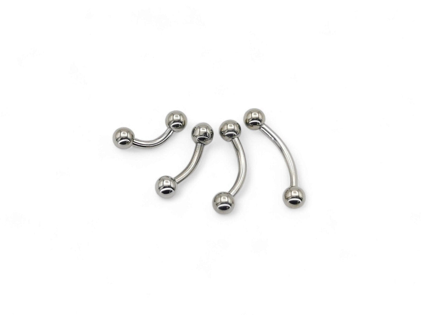 A set of four titanium curved barbells with screw fit balls, intended for various types of body piercings.