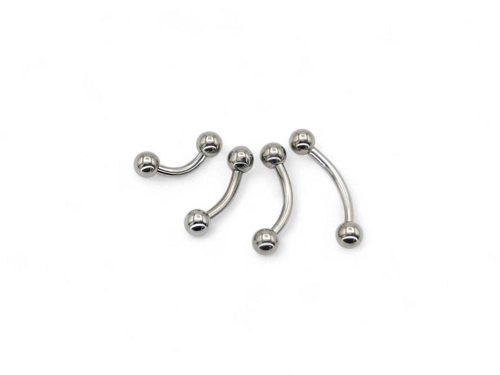 A set of four titanium curved barbells with screw fit balls, intended for various types of body piercings.
