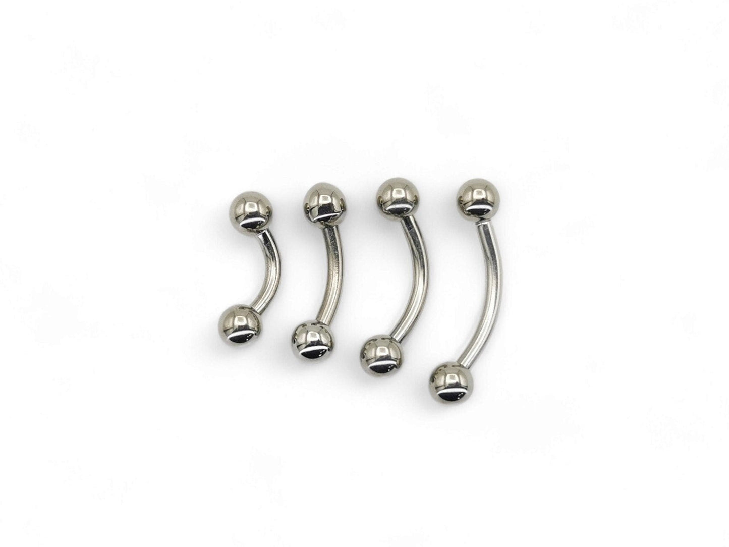 A set of four titanium curved barbells with screw fit balls, intended for various types of body piercings.