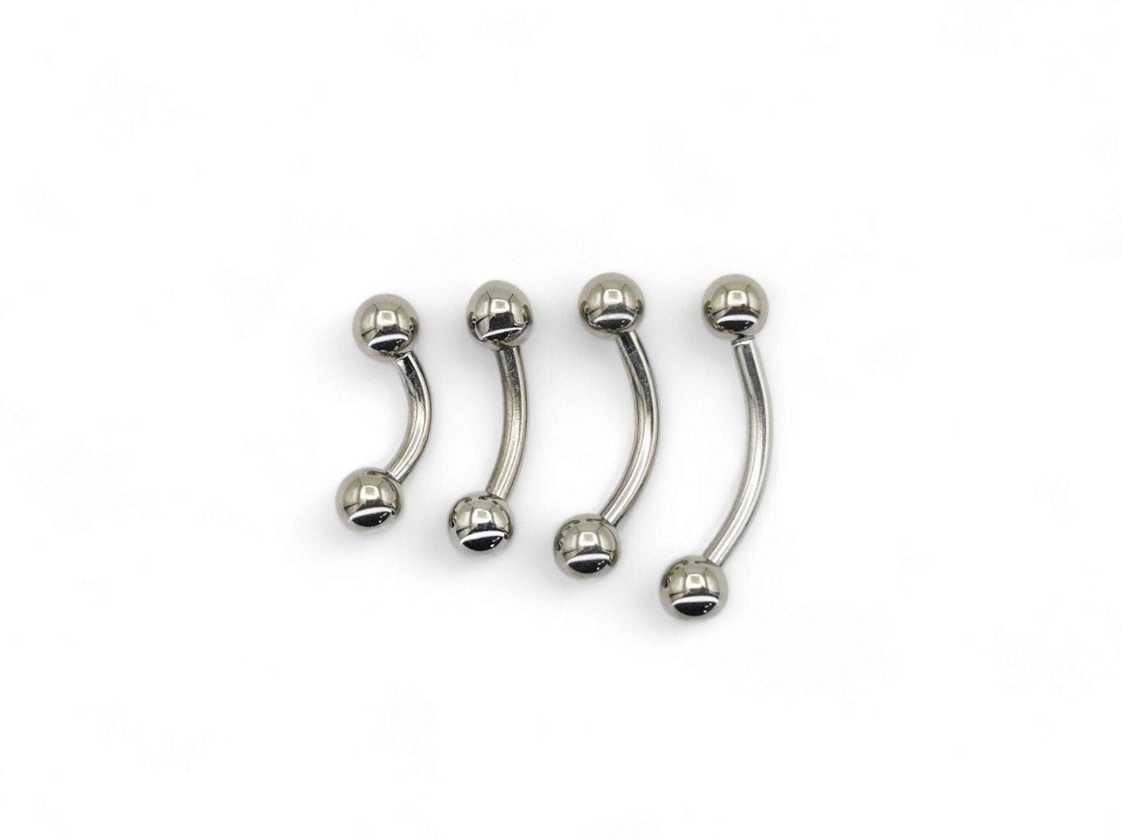 A set of four titanium curved barbells with screw fit balls, intended for various types of body piercings.