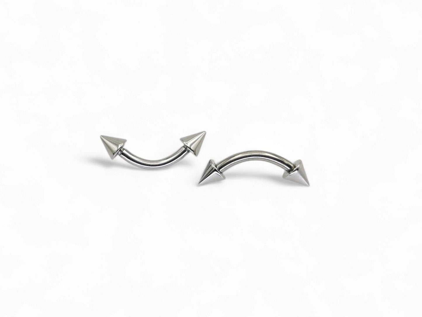 Surgical steel curved barbell with spikes, intended for eyebrow, rook, and anti tragus piercings.