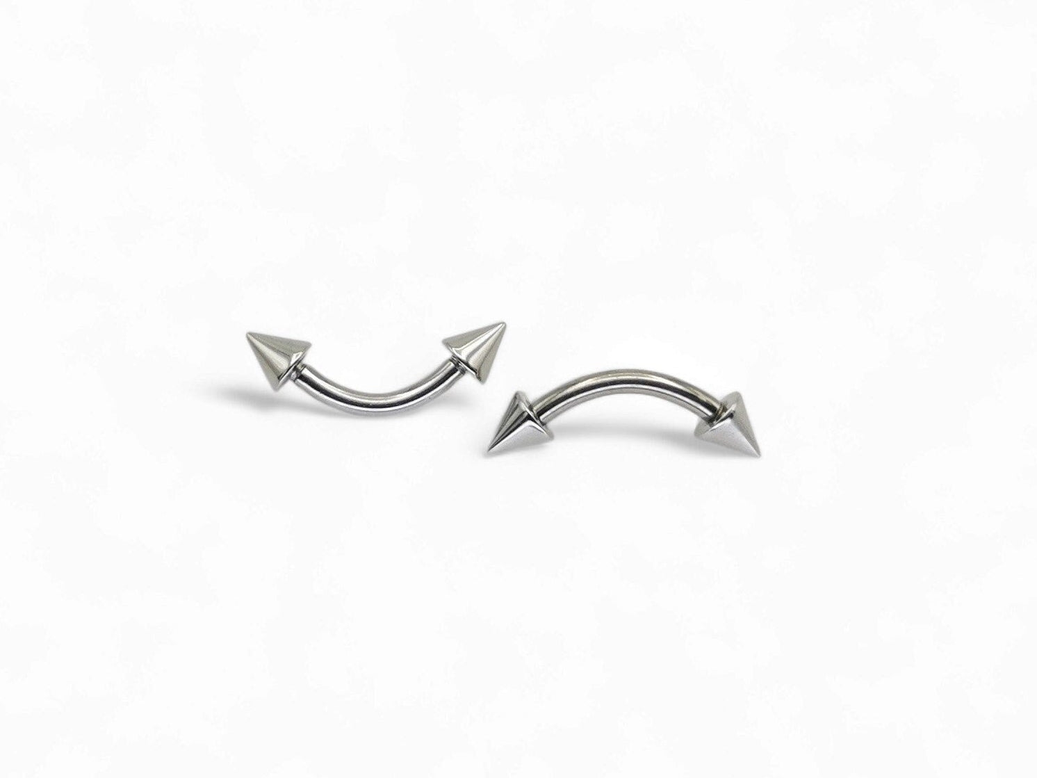 Surgical steel curved barbell with spikes, intended for eyebrow, rook, and anti tragus piercings.