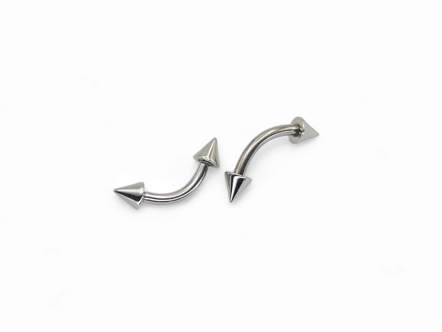 Surgical steel curved barbell with spikes, intended for eyebrow, rook, and anti tragus piercings.