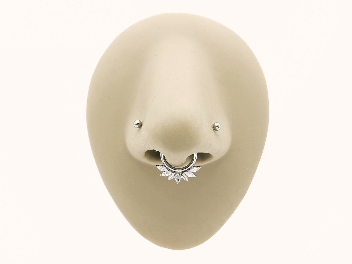 Titanium fan clicker set with marquise in a mannequin nose