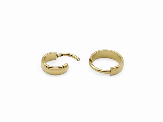 Titanium gold band clicker ring on a white background